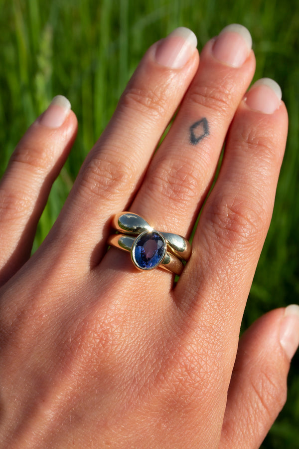 1.72ct Tanzanite Takara Ring on finger paired with Figure Ring.